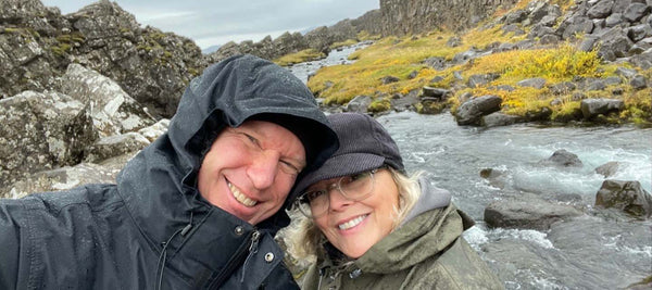 couple in front of a river