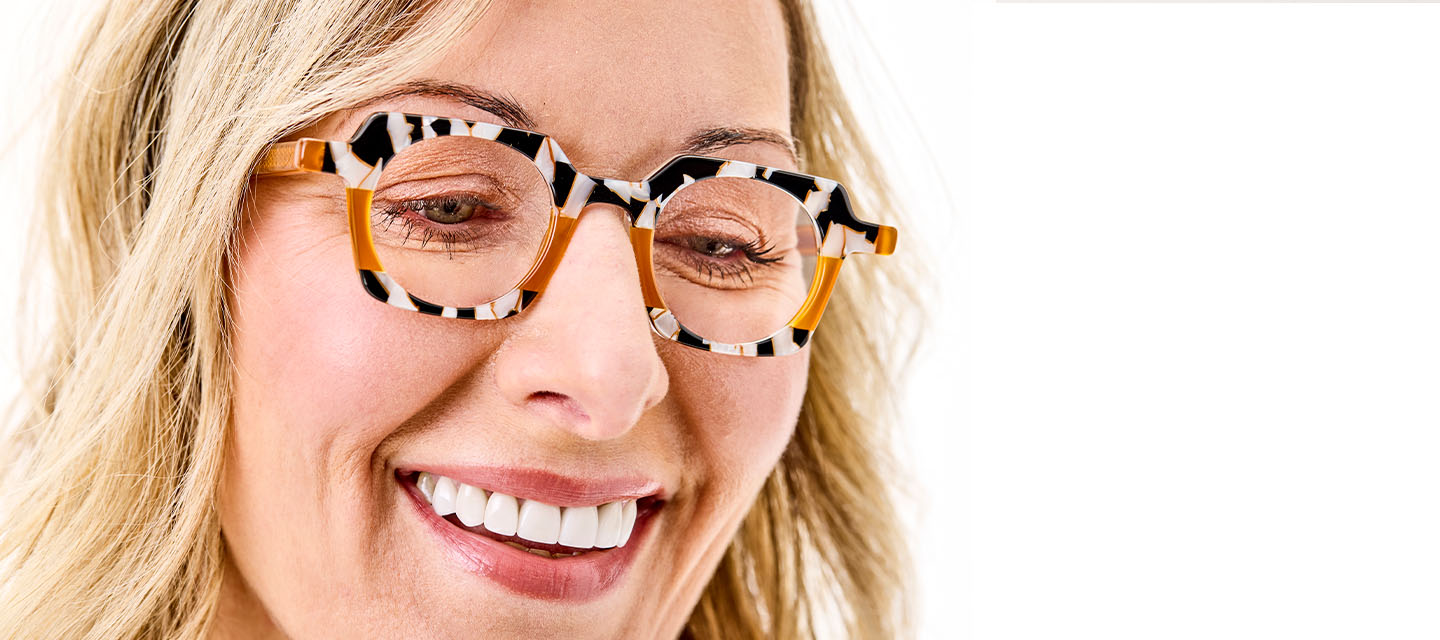 closeup of a blonde haired woman wearing zebra print geometric frames