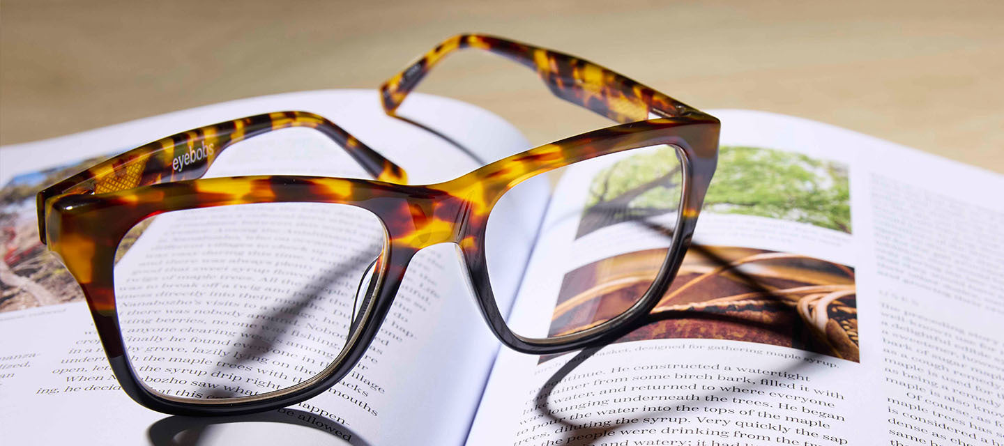 turtle shell glasses reflecting light on a book