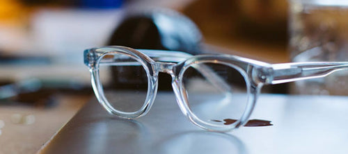 clear frame blue light glasses on desk