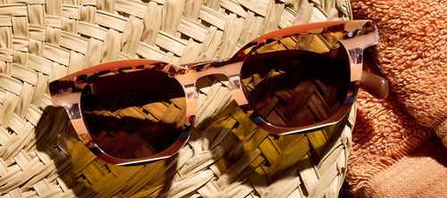 sunglasses on a straw hat