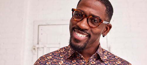 headshot of a man wearing tortoise shell glasses