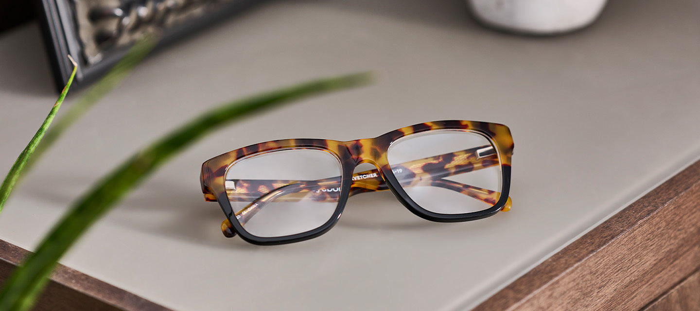 tortoise shell glasses on a counter top