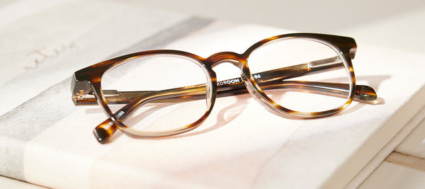 tortoise shell glasses on a closed white book