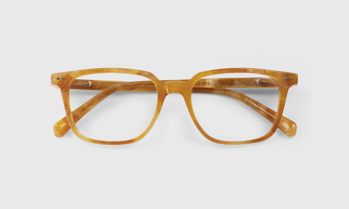  C Suite laydown eyeglass frames on neutral background.