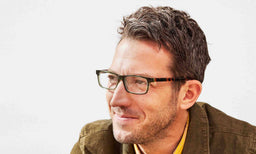 Number Cruncher reading glasses with italian-designed acetate frames and scratch resistant lenses on a smiling man