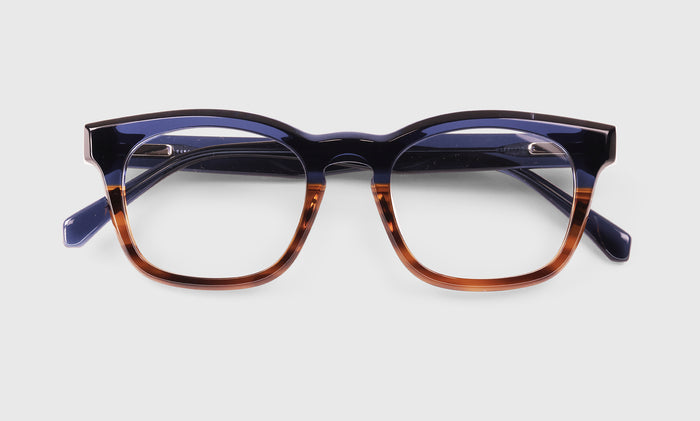  Humble Narrator laydown eyeglass frames on neutral background.