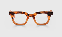 Square eyeglasses with tortoise pattern fading to amber acetate front and temples on a light gray background