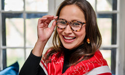 Woman wearing Holy Smokes eyeglass frames in a studio portrait for the campaign