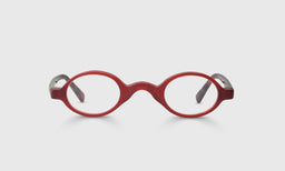 Narrow oval unisex glasses with matte red front and red temples flecked with black on light gray background