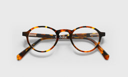 19_eyebobs premium designer board stiff readers, blue light and prescription glasses in tortoise front and temples, laydown