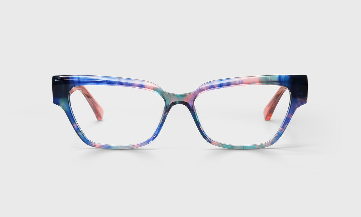 Cat-eye glasses with blue and pink demi front frame and translucent pink crystal temples on a light gray background
