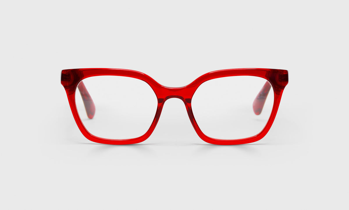 Narrow women's cat-eye prescription glasses with translucent red crystal frame and temples on a light gray background