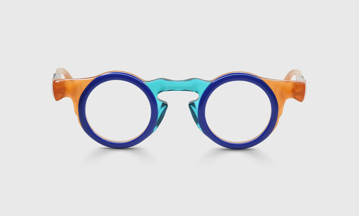 Round eyeglasses with bold indigo front, crystal teal bridge, and crystal tangerine temples on pale gray background