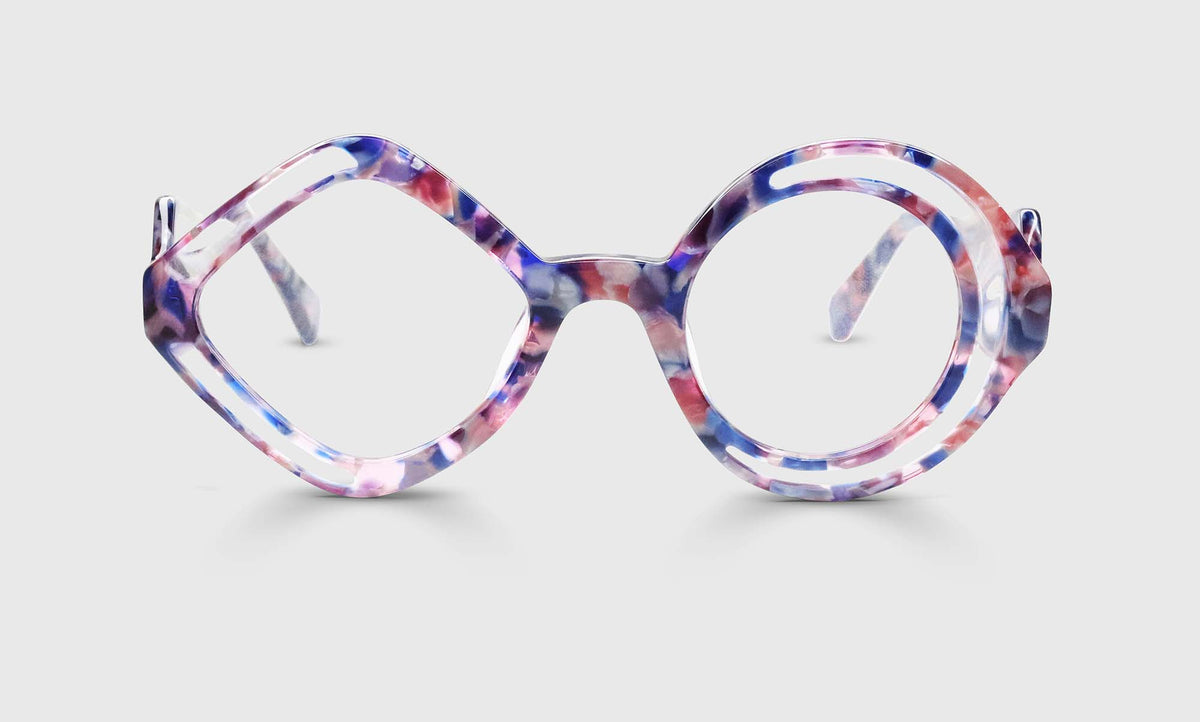 Round eyeglasses with rose, violet, and cobalt watercolor frames disrupted by clear geometric shapes on light gray background