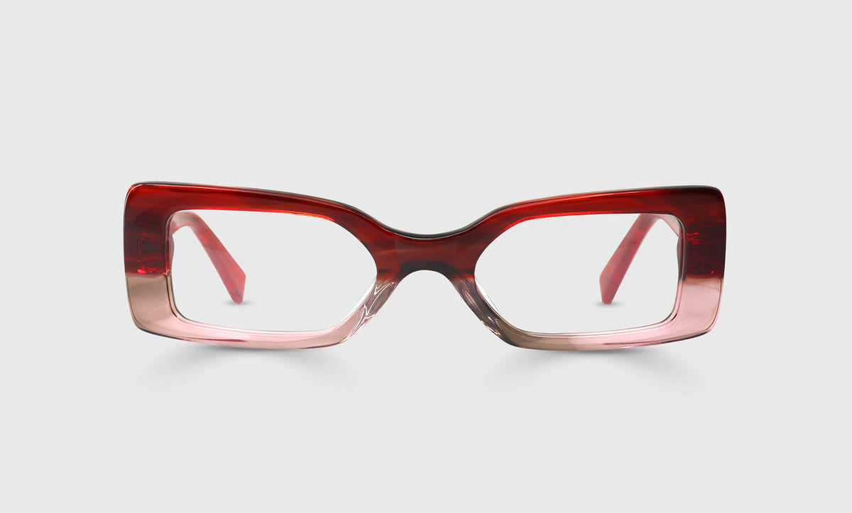 Wide rectangular eyeglasses with a cherry to blush gradient front and solid red temples on a light gray background