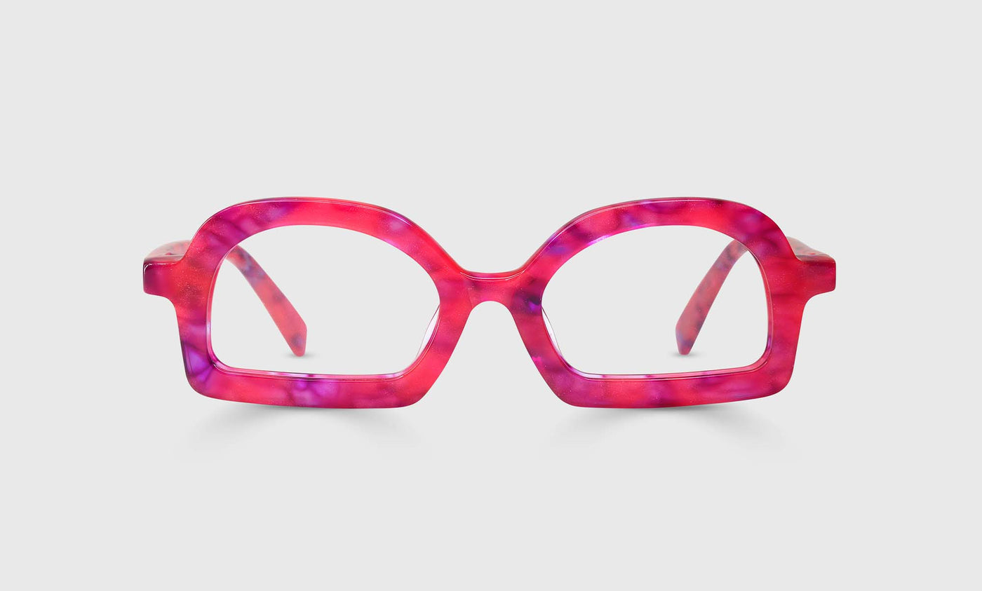 Round acetate eyeglasses with speckled pink and purple front and temples on a light gray background