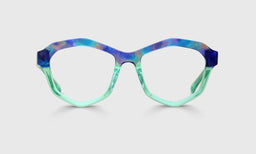 Geometric acetate eyeglasses in blue-purple tortoise top frame with translucent sea glass lower front and temples on gray background