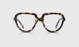 Narrow oval eyeglasses with glossy tortoise acetate frame and temples on a plain light gray background