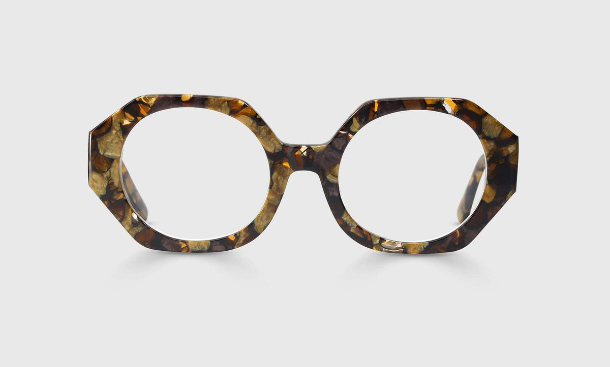 Geometric eyeglasses with brown and gold mottled acetate frame and temples on light gray background