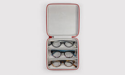 gallery position 1 top-down view of open red Frequent Flyer 3-Pair Case with three pairs of glasses inside and soft interior