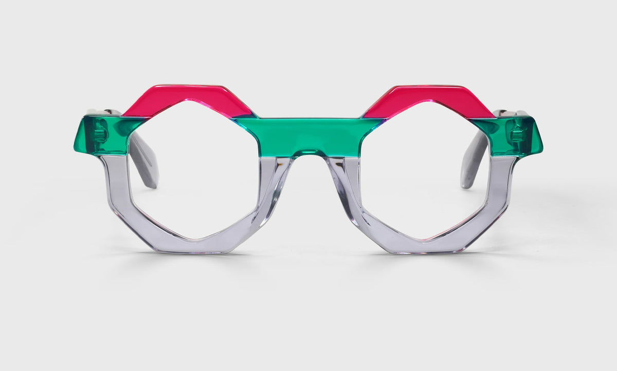Octagonal eyeglasses with translucent mint green bridge, silver lower rims, and bright fuchsia upper frame on pale gray background