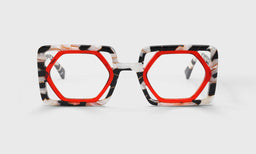 Oversized hexagonal eyeglasses with vibrant warm crimson inner frame and black and white marble textured outer rims on white background