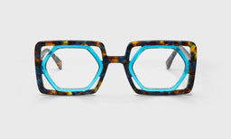 Hexagonal eyeglasses with cool aquamarine inner frame and textured tortoiseshell umber pattern on bold outer rims