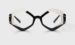 Angular eyeglasses with bold black and white frames and polished stainless steel temples on a neutral background
